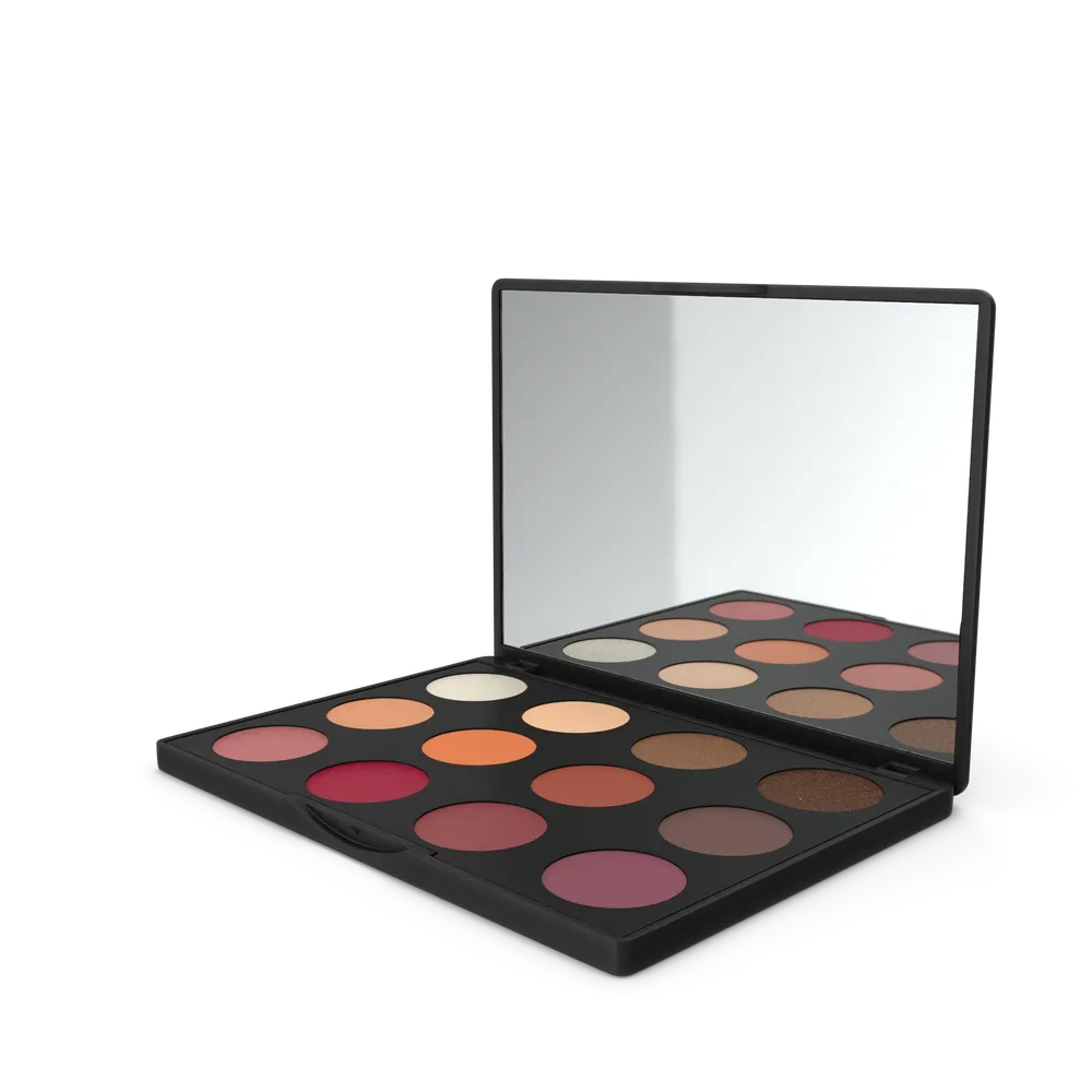 Open eyeshadow palette with multiple shade compartments and built-in mirror on a neutral background