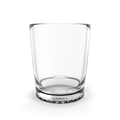 Clear elegant drinking glass filled with a colorful beverage on a clean white surface