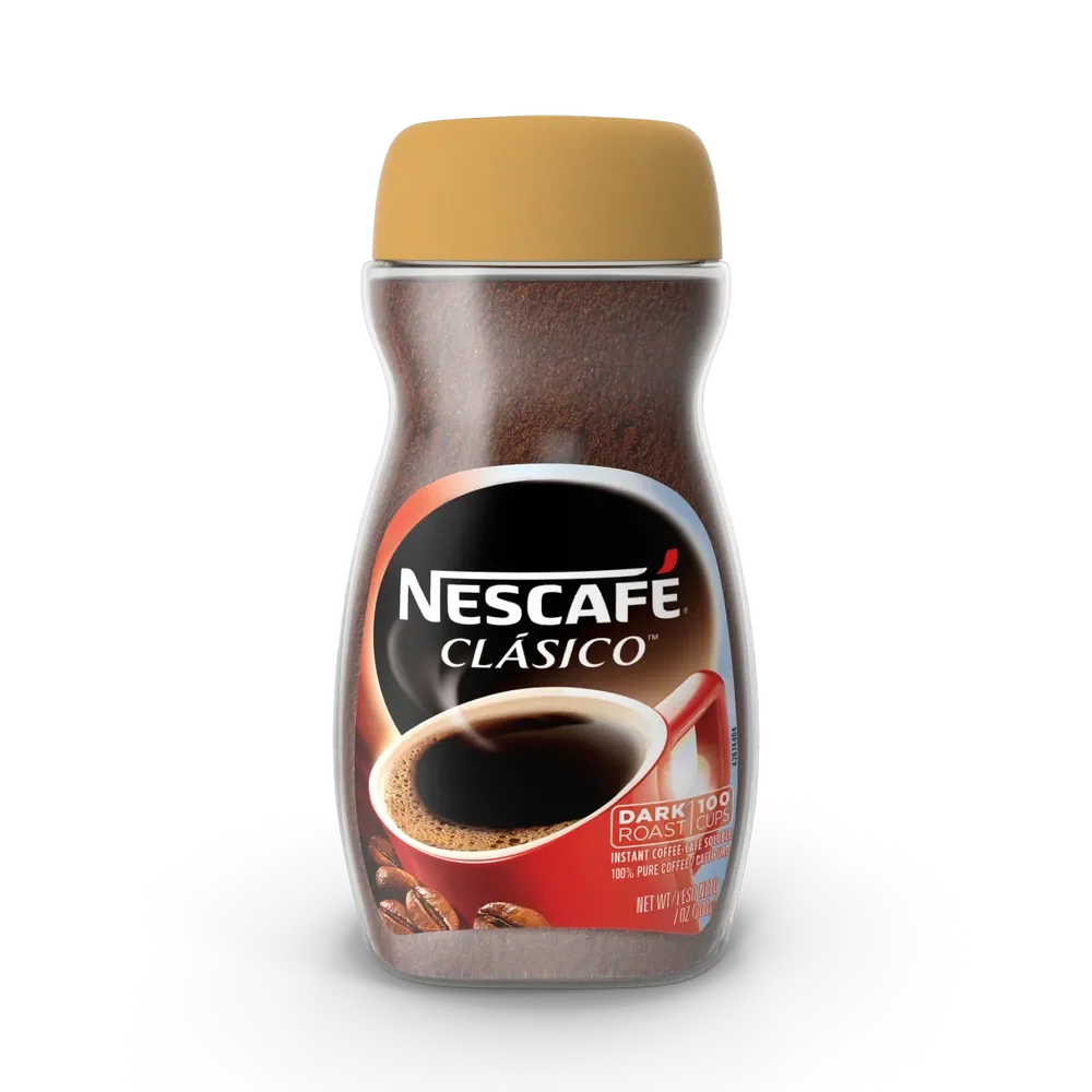 Nescafe instant coffee jar with rich dark coffee blend on a warm kitchen countertop