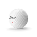 White dimpled golf ball resting on a golf tee on a green fairway