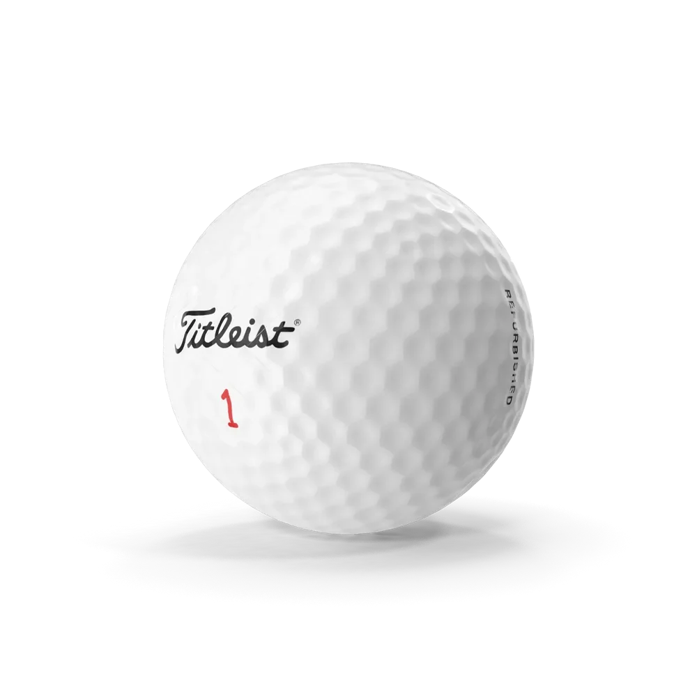 White dimpled golf ball resting on a golf tee on a green fairway