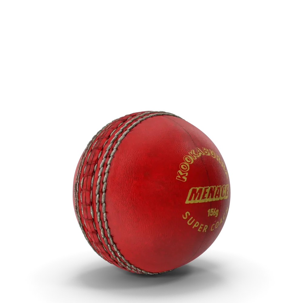 Hard red leather cricket ball with visible seam on a cricket pitch surface