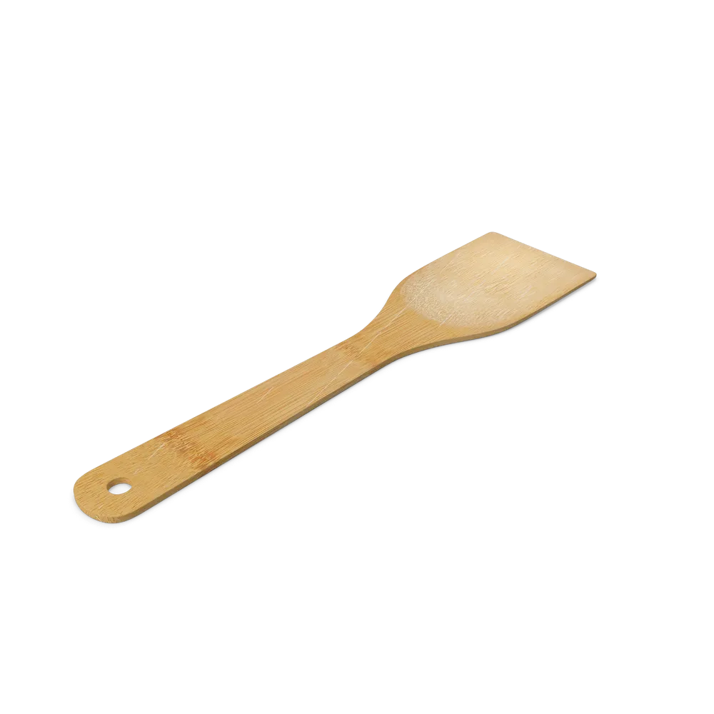 Eco-friendly bamboo spatula with smooth natural finish resting on a wooden kitchen countertop