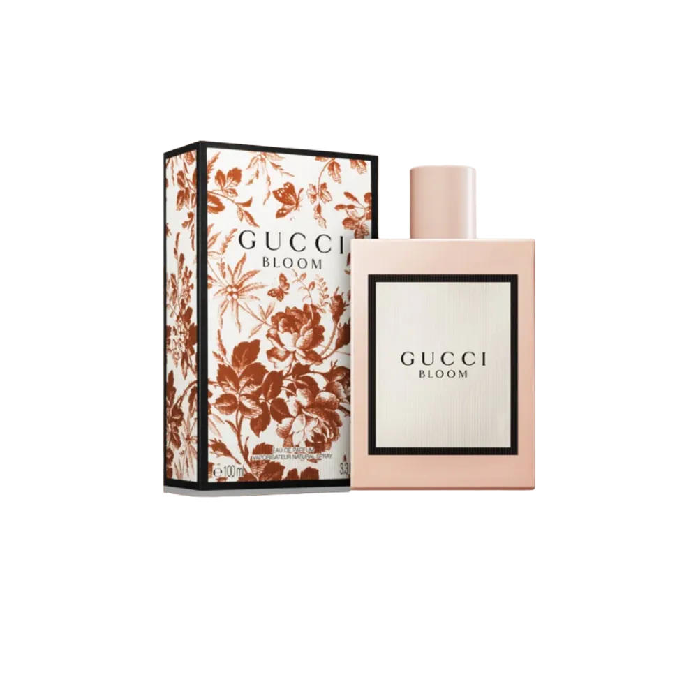 Gucci Bloom fragrance bottle surrounded by fresh jasmine and tuberose flowers